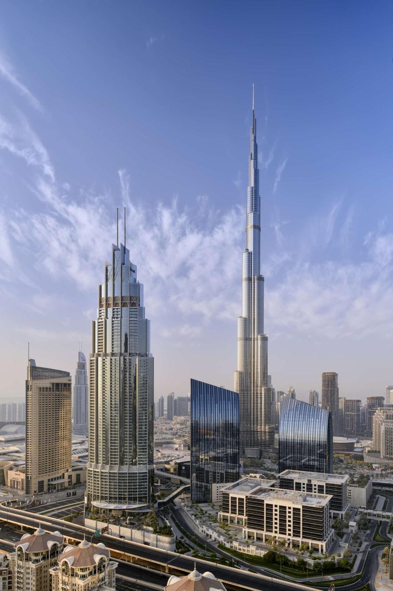 Kempinski The Boulevard Dubai Exterior photo The tower (right) with the Burj Khalifa (left)